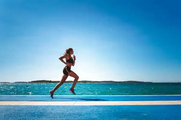 Woman running showing strong leg muscle Newark on Trent